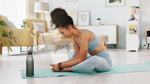 Image of Fitness, yoga or meditation stretching woman for workout in the living room of her house. Girl with chakra focus, mindset or balance while training, exercise or health with zen pilates for wellness.