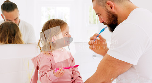 Image of Father, learning and teaching girl to brush teeth with toothbrush, dental hygiene and gum healthcare. Man, daughter and laughing in bathroom, healthy mouth or wellness with support for cleaning tooth