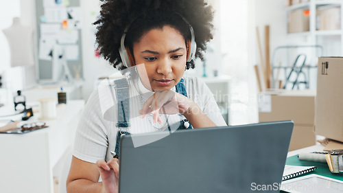 Image of Black woman, laptop and notebook to study in office, home or studio to design. Woman, music and listening on headphones while learning online, with computer or pc at desk, in house or workplace