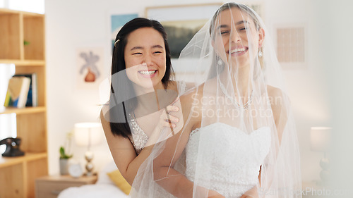 Image of Wedding veil of woman with friends help in dressing room. Happy people, women love and bridesmaid support or helping bride with fitting designer fabric on her head for beauty, marriage and happiness