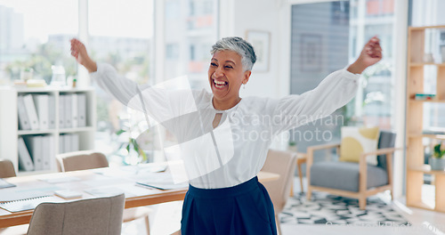 Image of Dance, success and business woman in an office, corporate celebration and happy with work freedom. Smile, winning and elderly employee funny dancing for promotion, bonus and achievement in career