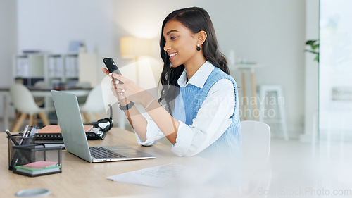 Image of Young businesswoman talking on her phone to a client in an office. Trendy marketing professional on scheduled time, using the online app for networking. Entrepreneur staying connected in a workplace