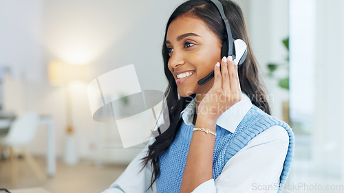 Image of Friendly call center agent using a headset while consulting for customer service and sales support. Confident and happy young business woman smiling while operating a helpdesk and talking to clients