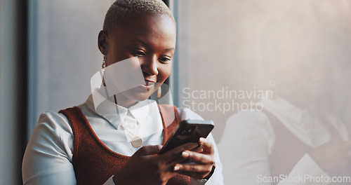 Image of Black woman, business and typing on phone at window in office building for social networking connection, mobile app and reading notification. Happy worker, smartphone and search media on digital tech