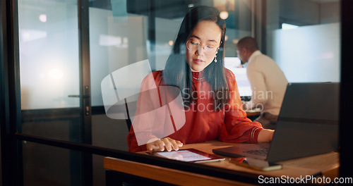 Image of Laptop, night office and Asian woman typing email, sales proposal or finishing project deadline. Computer, tech and happy female employee working late in dark workplace, researching or writing report