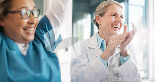 Image of Doctor, team and applause in celebration for healthcare achievement, goal or success at the hospital. Group of medical professional clapping and celebrating teamwork, unity or victory at clinic