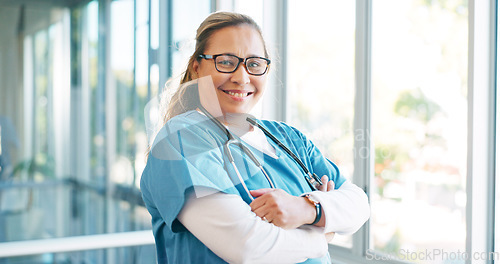 Image of Portrait, healthcare and trust with a nurse woman in scrubs standing arms crossed while working in a hospital. Medical, health and insurance with a female medicine professional at work in a clinic