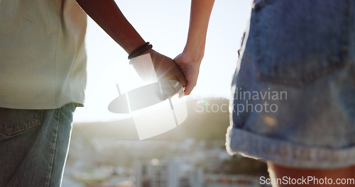 Image of Summer, love and couple holding hands in the city of Portugal for a holiday together. Support, trust and man and woman with affection, sunshine view and travel on a vacation for adventure with flare