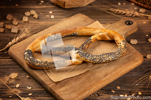 Image of Freshly baked pretzel with poppy seeds