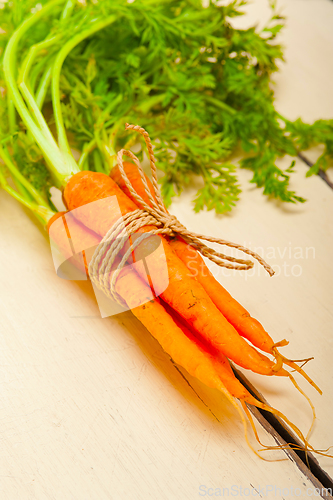 Image of baby carrots bunch tied with rope