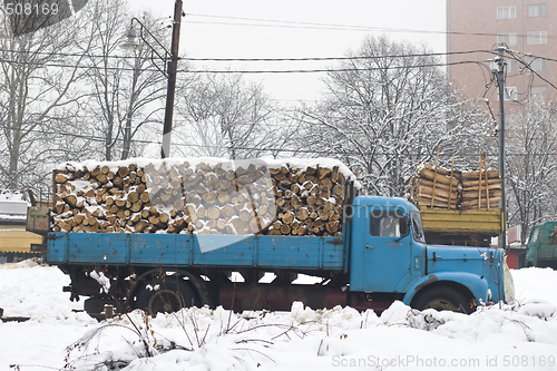 Image of old truck with firewood in the snow