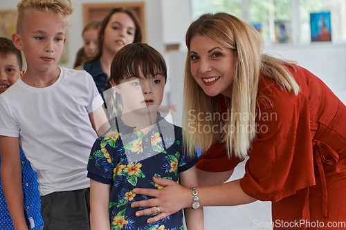 Image of Preschool children wait in line for new and interesting games. Selective focus