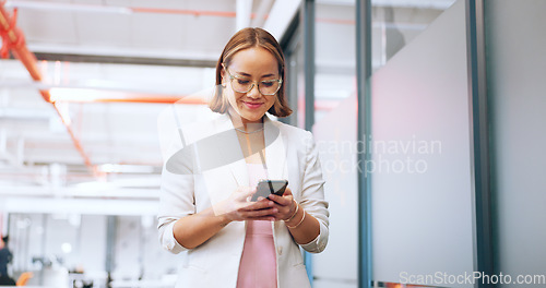 Image of Business woman in office walking with smartphone for Seoul, global or international networking, communication and marketing. Happy asian employee using phone or cellphone in a corporate workspace