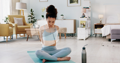 Image of Fitness, yoga or meditation stretching woman for workout in the living room of her house. Girl with chakra focus, mindset or balance while training, exercise or health with zen pilates for wellness.