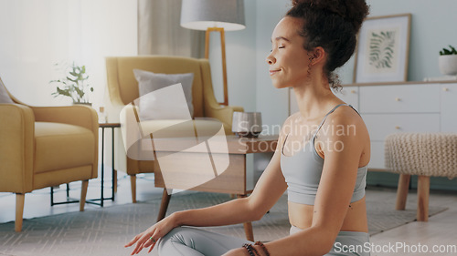 Image of Meditation, pilates and home yoga for black woman working on spiritual chakra peace, freedom of the mind and zen mindset. Body health, wellness lifestyle and relax girl training on living room floor