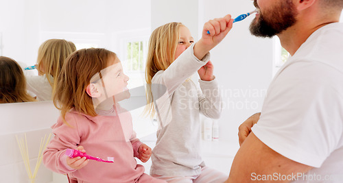 Image of Girl children, father and brushing teeth for bonding and being happy for bathroom, playful and laugh together. Growth, child development and dad teach female kids oral hygiene, healthcare and dental.