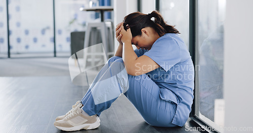 Image of Healthcare, stress and sad nurse on floor with burnout, anxiety and headache working in emergency services. Medical care, mental health and health care worker with depression in hospital or clinic