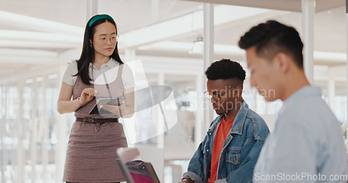 Image of Asian business woman, tablet or mentor in digital marketing company, advertising coworking space or branding education. Creative designer, speaker or team work meeting diversity with kpi technology