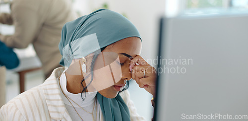 Image of Hijab, headache and business woman burnout at a office computer feeling anxiety and stress. Finance employee, islam and muslim female at work doing tax audit at a computer worried about mistake