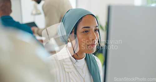 Image of Woman, startup and desk with computer, reading and coding in modern office with islamic headscarf. Muslim programming expert, developer and web design worker with vision, tech solution and happiness