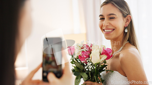 Image of Bride, bridesmaid and wedding picture with phone with flowers or bouquet, fashion dress and an excited smile for social media. Happy woman and friend with mobile smartphone before a marriage ceremony