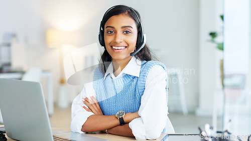 Image of Portrait of a call center agent using a headset while consulting for customer service and sales support. Confident young businesswoman smiling while operating a helpdesk and looking confident