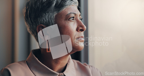Image of Shot of a mature businesswoman looking stressed out in an office