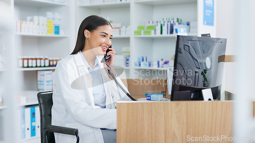 Image of Pharmacist woman answering the telephone and giving advice to customer on flu shot treatment options in pharmacy. Chemist assisting remote client by checking medicine stock on their computer database