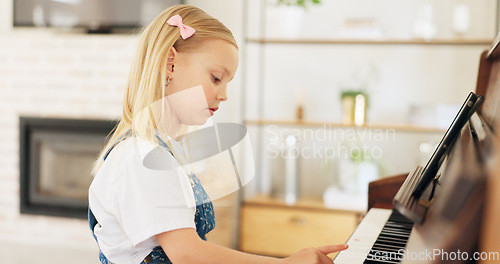 Image of Development, young girl and piano for learning, practice and keys for instrument being focus, concentrate and educate. Music, tablet and child education for playing, lesson and training art at home.