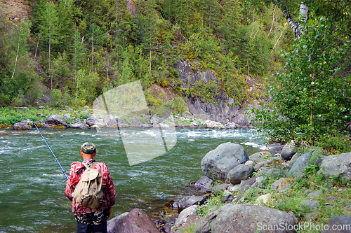 Image of Fisherman on clean mountain river year daytime