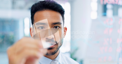 Image of Thinking, strategy and serious businessman writing on glass wall with thoughtful analysis in office. Brainstorming, planning and vision of corporate worker with focus, concentration and idea.