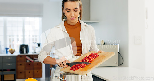 Image of Woman, cooking and kitchen, vegetable and nutrition, board and knife, healthy food and diet at home. Young, chef and chop pepper with tomato, nutritional meal and fresh, organic and raw.