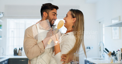 Image of Singing, happy and dancing funny couple together in a kitchen at home enjoy their relationship and crazy together. Man and woman sharing playful dance, love and smile after cooking with apron in home