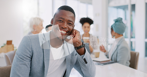 Image of Meeting, office and face of a professional black man sitting at a table with a corporate team. Happy, smile and portrait of African businessman working on company project with colleagues in workplace