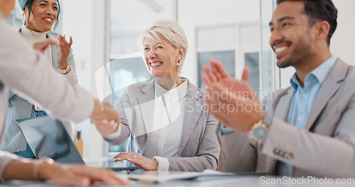 Image of Handshake, partnership and business people clapping hands in celebration, congratulations or motivation. Collaboration, applause and senior woman shaking hands with company partner after success deal