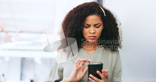 Image of Phone, black woman and frustrated frown of a person on digital communication reading fake news. Annoyed woman on web, internet and social media scroll confused about digital media reading in a office