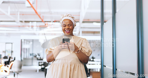 Image of Black woman, phone and communication with a business contact while walking in a creative office laughing about funny meme notification. Happy african employee using mobile data on social network