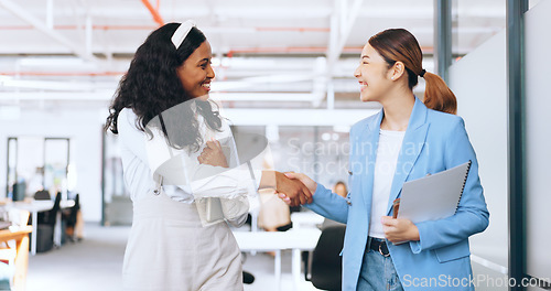 Image of Business women, handshake and welcome, introduction and hello to new intern while walking in office. Happy, excited and diversity workers shaking hands for support, teamwork or onboarding partnership