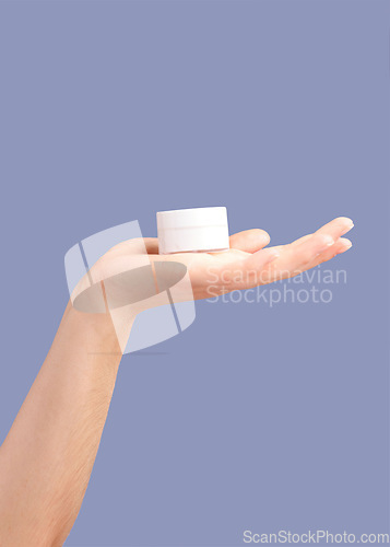 Image of Hands, skincare and cream container in studio isolated on a purple background for hydration. Cosmetics, dermatology and woman or female model with lotion, creme or moisturizer for beauty aesthetics.