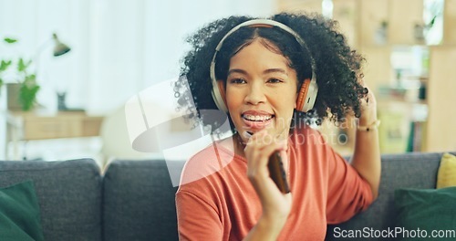 Image of Black woman, dancing and headphones on sofa, being content and singing words in living room. Young girl, headset and digital device for contemporary dancer, moving with rhythm and relax on break.