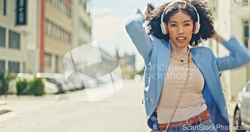 Image of Music, street and black woman dance with energy, wellness and freedom while streaming rap, hip hop or radio sound. Headphones, crazy fun and retro dancer listening to audio song while dancing in city