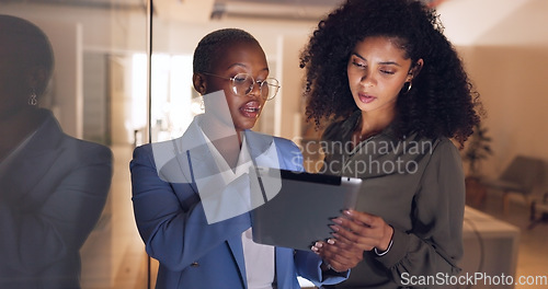 Image of Business people, tablet or talking in night office for digital marketing startup, creative company or project management teamwork. Designer, worker or black woman on technology for strategy planning