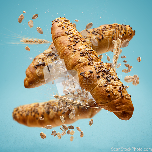 Image of Freshly baked rolls fly in the air.