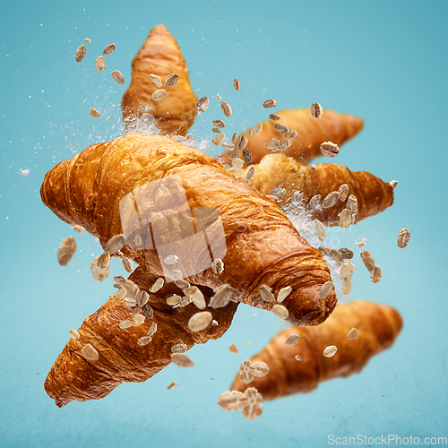 Image of Freshly baked croissant flying in air