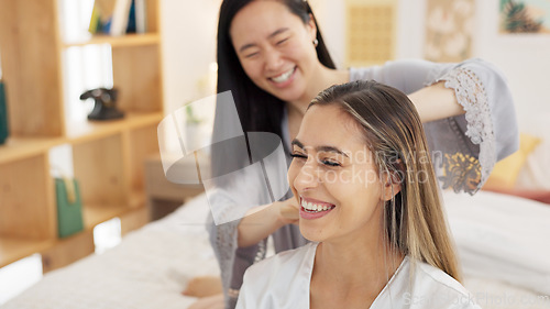 Image of Friends, brush hair and women in bedroom get ready for bed, girls night out or special event. Happy, smile and girlfriends grooming at sleepover at home. Asian girl and friend talk in pajamas on bed.