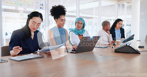 Image of Laptop, documents and teamwork of business people in meeting. Planning, writing and group of women with computer and paperwork discussing sales, advertising or marketing strategy in company office