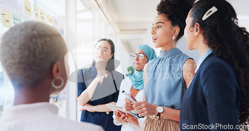 Image of Sticky note, planning and business women in meeting sit down in office. Teamwork, collaboration and group of people sitting after brainstorming sales, advertising or marketing strategy on glass wall.