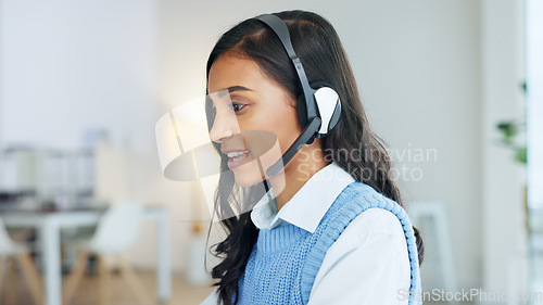 Image of Friendly call center agent using a headset while consulting for customer service and sales support. Confident and happy young business woman smiling while operating a helpdesk and talking to clients