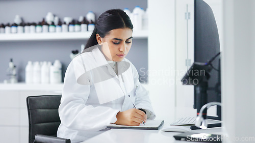 Image of Young scientist using a computer and microscope in a lab. Female pathologist analyzing medical samples while doing experiments to develop a cure. Microbiologist conducting forensic research