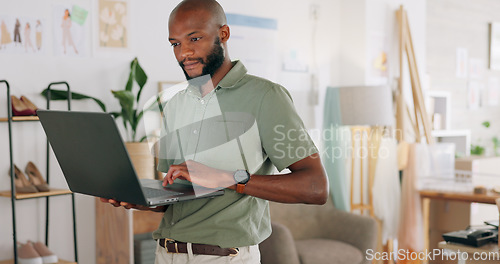 Image of Laptop, creative and online order with a black man designer working in a workshop for shipping or delivery. Computer, ecommerce and logistics with a male managing stock or the shipment of goods